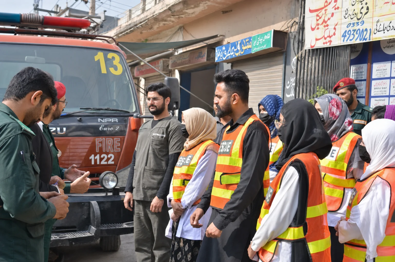 YMC team beside a local fire and rescue vehicle